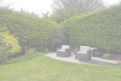 A beautifully maintained garden space with comf...