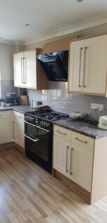 A modern and tidy kitchenette featuring ample s...