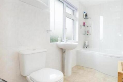 A bright and clean bathroom featuring modern fi...