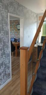 A spacious and tidy hallway leading to a vibran...