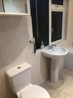 A clean and modern bathroom featuring a sink an...