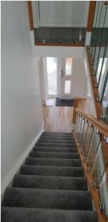 A clean and well-lit staircase leading to the e...