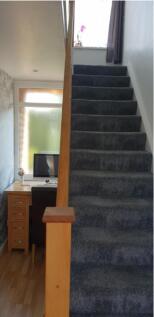 A well-maintained staircase leading to a bright...