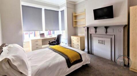 A well-maintained bedroom with a comfortable be...