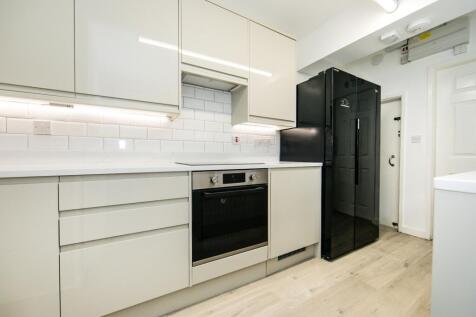 A modern, well-maintained kitchen featuring whi...