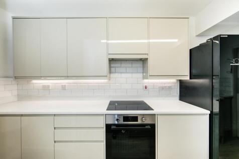 Modern, well-maintained kitchen with clean whit...