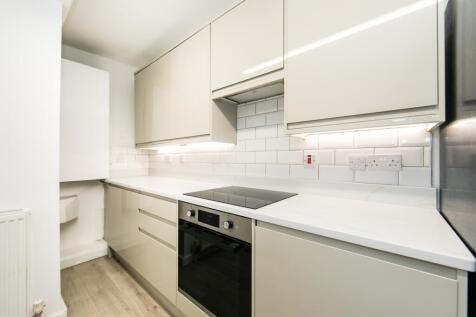 A modern, well-maintained kitchen with white ca...