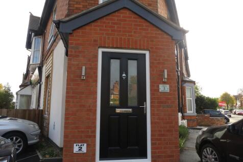 Well-maintained brick front entrance with a sty...