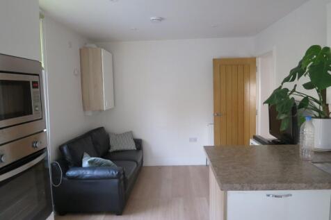 Bright, modern open-plan living area with a com...