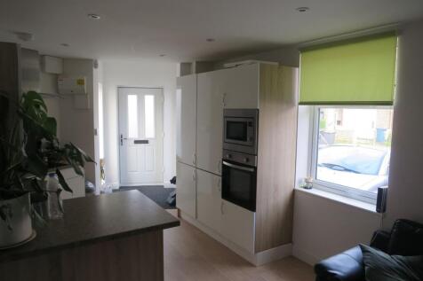Bright modern kitchen with integrated oven and ...