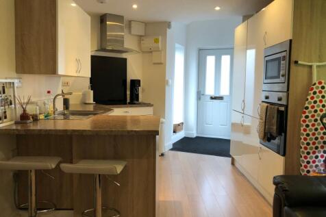 Modern galley-style kitchen with a breakfast ba...