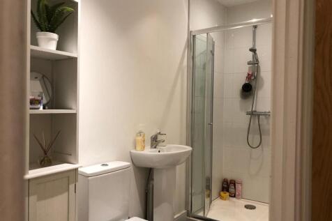 Bright, modern bathroom with a walk-in shower, ...