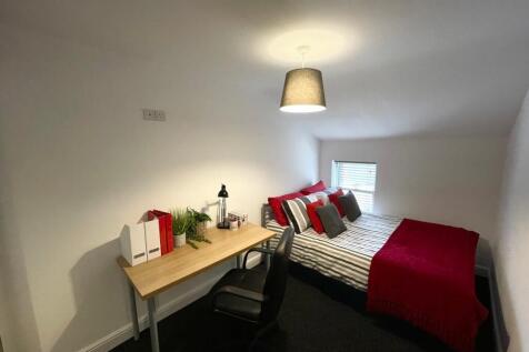 Bright, neatly presented bedroom with a double ...