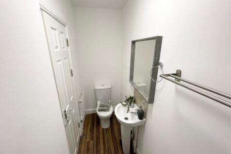 Bright, freshly decorated WC with a compact sin...