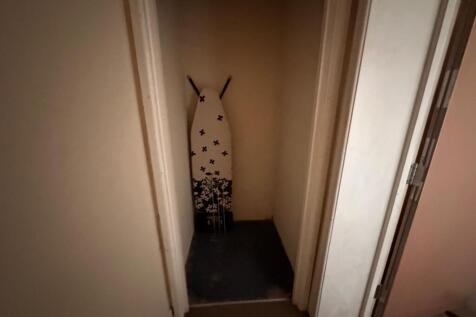 Small internal storage closet with an ironing b...