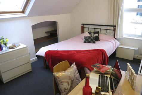 Bright loft-style double bedroom with a comfort...