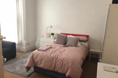 Bright, neatly presented bedroom with a comfort...