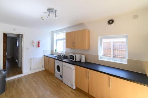Bright, modern kitchen with long worktops, ampl...