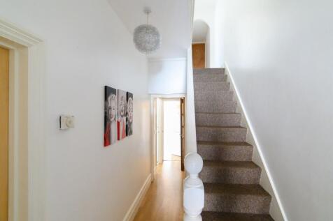 Bright, freshly painted hallway with carpeted s...