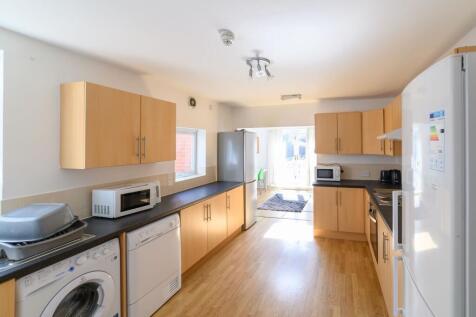 Bright, modern galley kitchen with plenty of st...