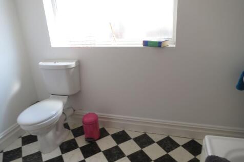 Bright, simple bathroom with classic black-and-...