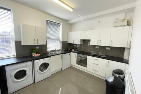 Bright modern kitchen with glossy floor tiles, ...