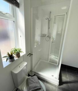 Bright, modern bathroom with a walk-in shower, ...