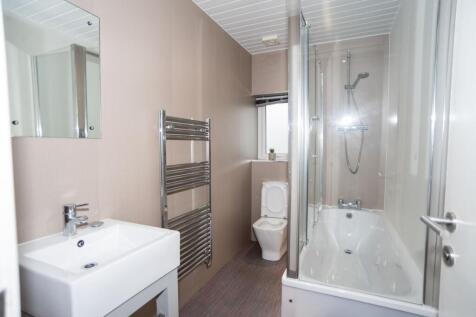 Bright, modern bathroom with a sleek white sink...