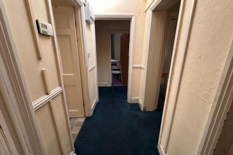 Bright internal hallway with contrasting dark c...