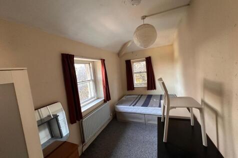 Bright single bedroom with two sash windows, fi...