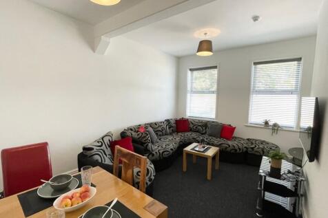 Bright, open living room with a large patterned...