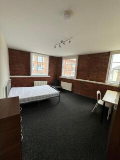 Spacious double bedroom with exposed brick wall...
