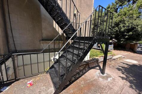Outdoor metal fire escape staircase leading fro...