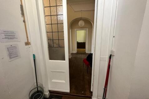 Welcoming entrance hallway with period door and...
