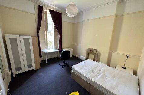 Bright single bedroom with high ceilings, tall ...