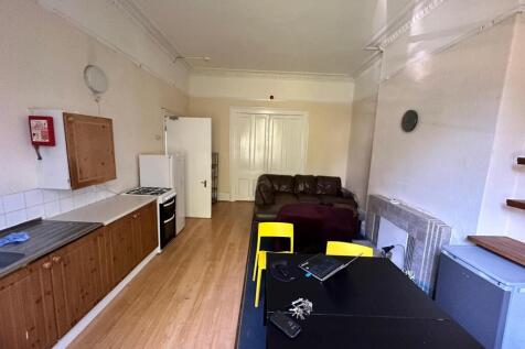 Open-plan kitchen and living area with a run of...