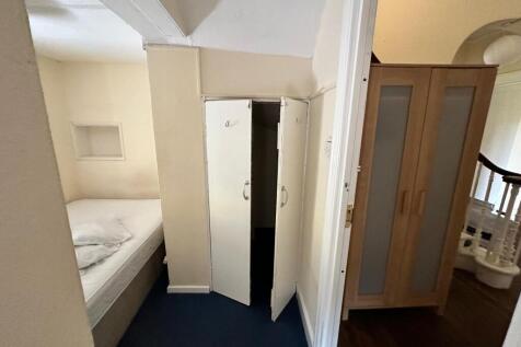 Cozy small bedroom with a single bed tucked int...