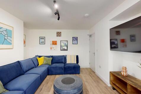 A bright and spacious living room featuring a l...