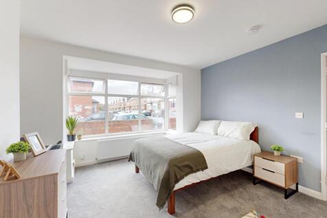 Bright and spacious master bedroom featuring a ...