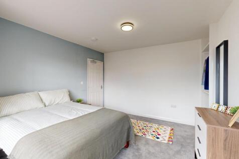 A bright and spacious master bedroom featuring ...