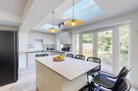 Bright and modern kitchen with ample natural li...