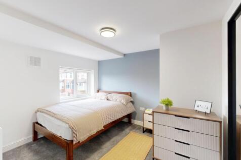 Bright and welcoming bedroom with a large windo...