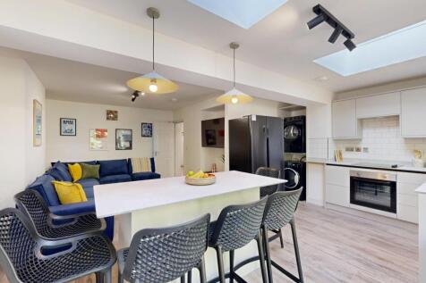 A modern, bright living area featuring a comfor...