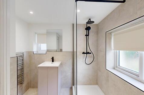A modern, well-maintained bathroom with a large...
