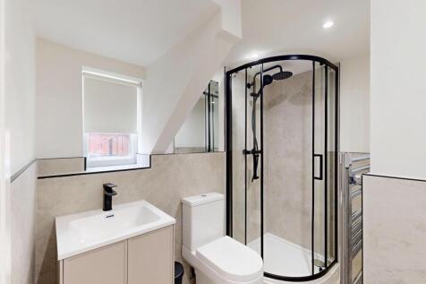 A modern, clean bathroom featuring a spacious s...