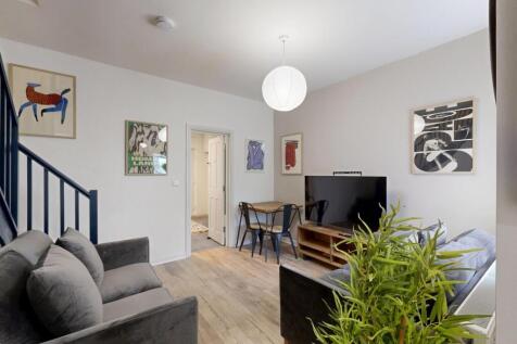 Bright and modern living room featuring a spaci...