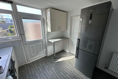 A modern kitchen featuring a large Samsung frid...