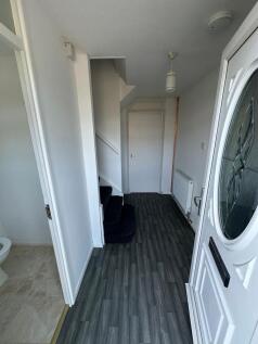 Bright and tidy hallway featuring modern dark w...