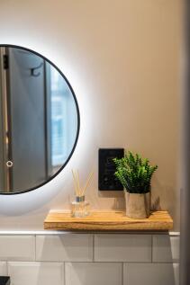 Stylish bathroom corner with a round illuminate...