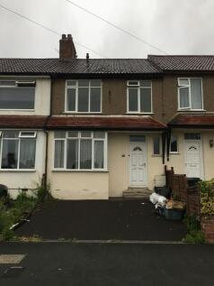 Terraced house exterior with a tiled roof, driv...